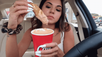 Woman In Car Eating Pizza And Drinking Caffe GIF