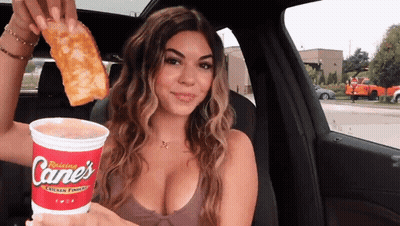 Woman In Car Holding Cane, Cup, And Pizza GIF
