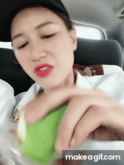 Woman In Car Holding Tennis Ball Saying Make A GIF