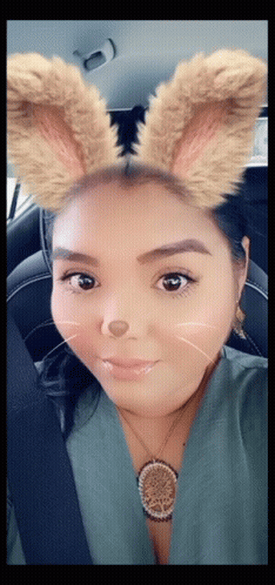 Woman In Car With Bunny Ears And Necklace GIF