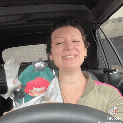 Woman In Car With Heaven Tattoo On Neck GIF