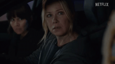 Woman In Car With Netflix Logo GIF