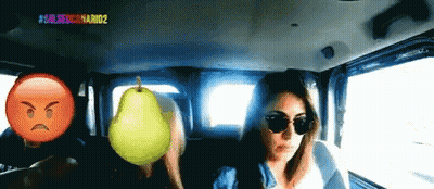 Woman In Car With Pear And Angry Face GIF