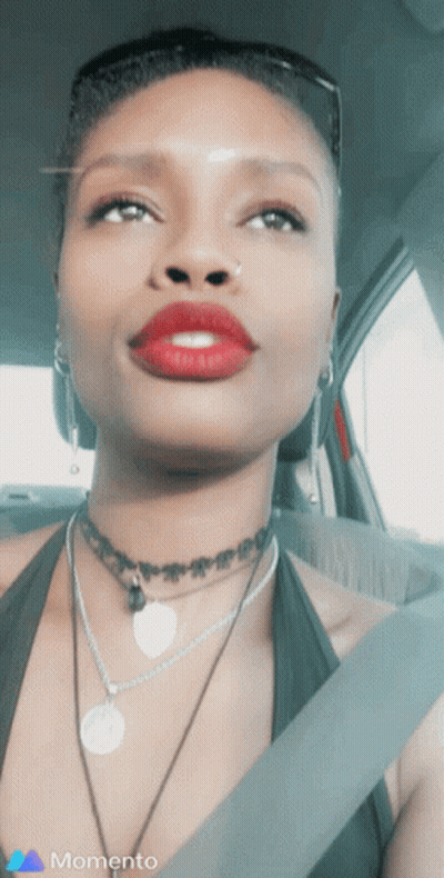 Woman In Car With Red Lipstick, Choker, And Memento Logo GIF