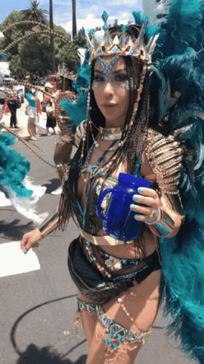 Woman In Carnival Costume Holding Blue Cup GIF