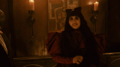 Woman In Cat Costume Holding Knife In Dark Room GIF