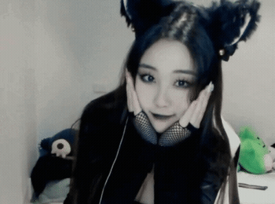 Woman In Cat Ears And Fishnet Gloves Holding Face GIF