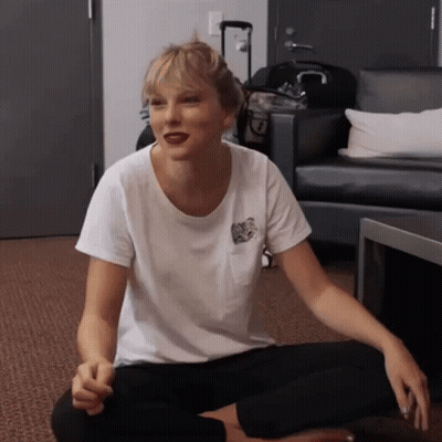 Woman In Cat T-Shirt Sitting On Floor GIF