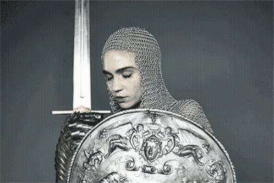 Woman In Chain Mail Holding Sword And Shield GIF