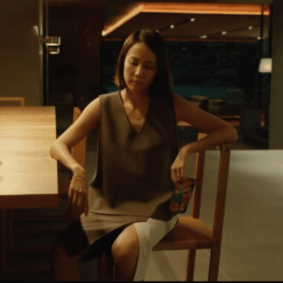 Woman In Chair Looking Down GIF