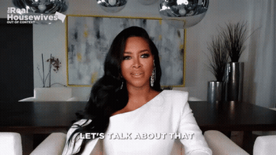 Woman In Chair Saying Let's Talk About That GIF