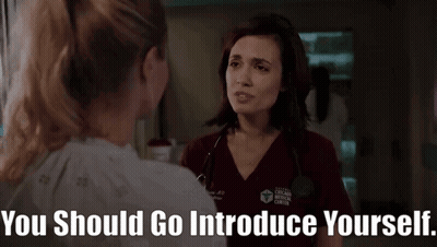 Woman In Chicago Medical Center Scrub Talking To Another Woman In Hospital Room GIF