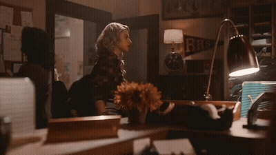Woman In Choker And Plaid Shirt Standing Next To Woman GIF