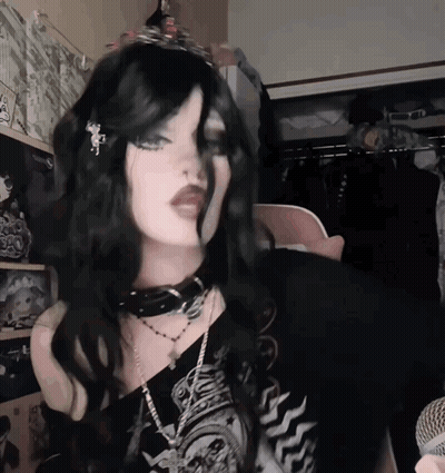 Woman In Choker And Tiara At Microphone GIF