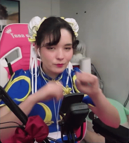 Woman In Chun Li Costume Sitting GIF