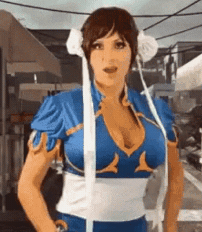 Woman In Chun Li Costume Standing In Front Of Umbrella GIF