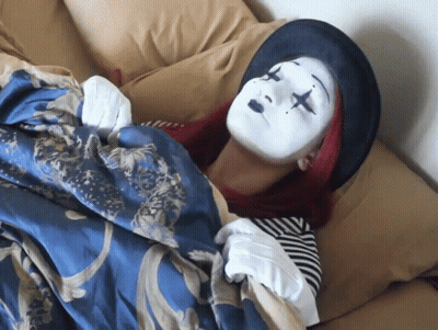 Woman In Clown Costume Laying On Bed GIF