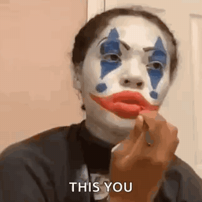 Woman In Clown Makeup Applying Red Lipstick GIF