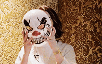 Woman In Clown Mask Standing In Front Of Wall GIF