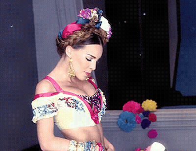 Woman In Colorful Crop Top And Earrings GIF