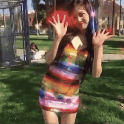 Woman In Colorful Dress And Headphones In Park GIF
