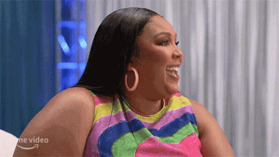 Woman In Colorful Dress And Hoop Earrings GIF