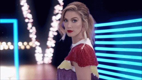 Woman In Colorful Dress In Front Of Blue Light GIF