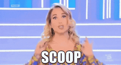Woman In Colorful Dress Making Scoop Gesture GIF
