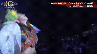 Woman In Colorful Outfit Dancing At 5 Star GP Sign GIF