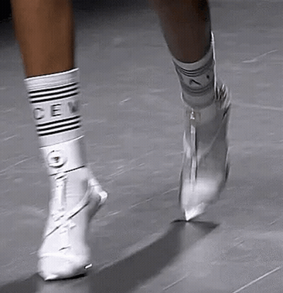 Woman In Colorful Outfit Walking Runway With Wrestling Belt GIF