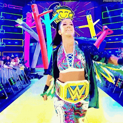 Woman In Colorful Outfit Walking Runway With Wrestling Belt GIF