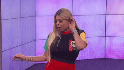 Woman In Colorful Shirt And Skirt With Purple Wall GIF