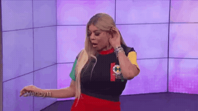 Woman In Colorful Shirt At Purple Wall GIF