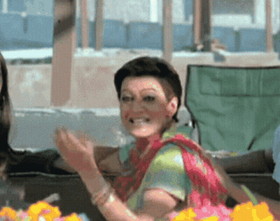 Woman In Colorful Shirt Clapping And Smiling GIF