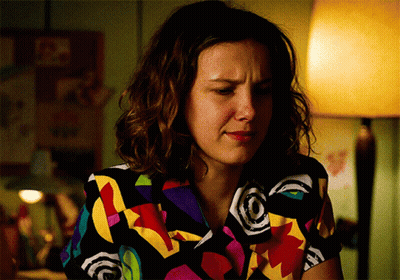 Woman In Colorful Shirt Sitting With Lamp GIF