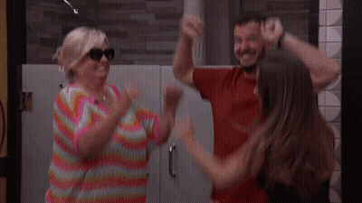 Woman In Colorful Sweater Dancing With Man And Woman GIF