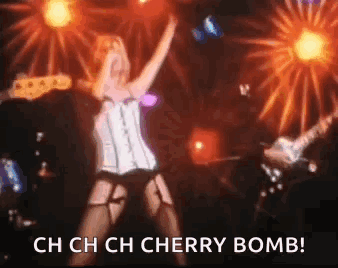 Woman In Corset Dancing On Stage With Guitar And Fireworks GIF