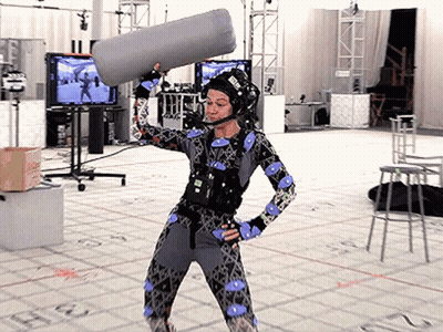 Woman In Costume Holding Microphone With E Helmet GIF