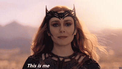 Woman In Costume Saying This Is Me In Front Of Mountains GIF