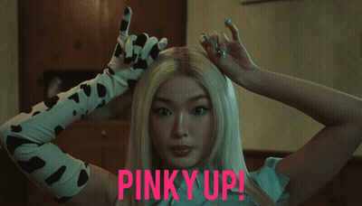 Woman In Cow Print Gloves Pinky Up GIF