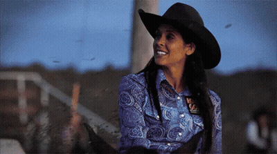 Woman in Cowboy Hat and Blue Shirt With Texas Badge