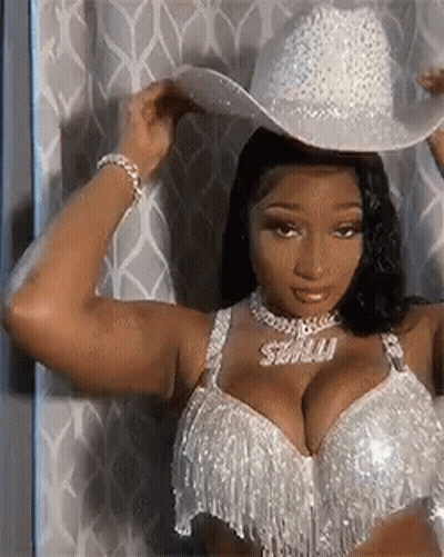 Woman In Cowboy Hat And Bra By Curtain GIF