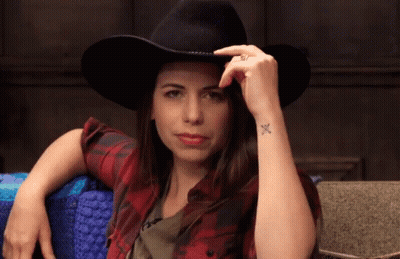 Woman In Cowboy Hat And Plaid Shirt With Wrist Tattoo GIF