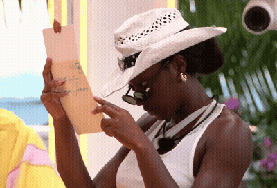 Woman In Cowboy Hat And Sunglasses Reading Note GIF