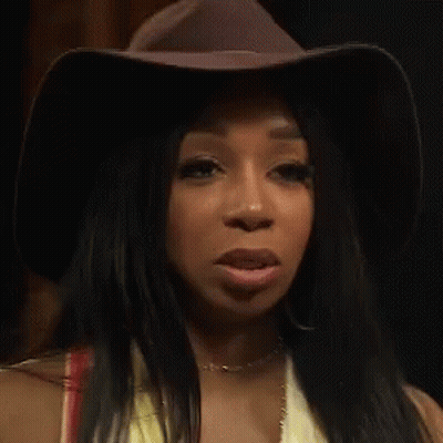 Woman In Cowboy Hat And Yellow Top Making A Face GIF