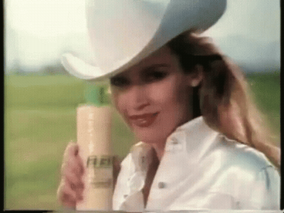 Woman In Cowboy Hat Holding Shampoo GIF
