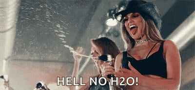 Woman In Cowboy Hat Holding Water Bottle GIF