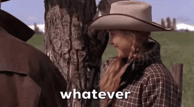 Woman In Cowboy Hat Saying Whatever Next To Man In Field GIF