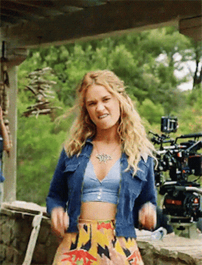 Woman In Crop Top And Denim Jacket GIF