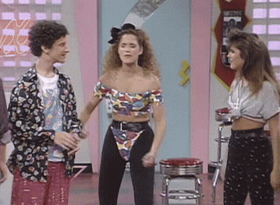 Woman In Crop Top And High Waisted Pants Standing Beside Couple GIF
